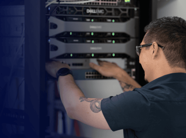 IT professional working on server racks in a data center.