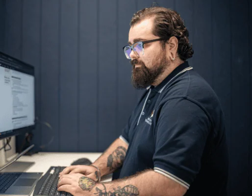 Man working on computer at Bigfish office, focused on screen.
